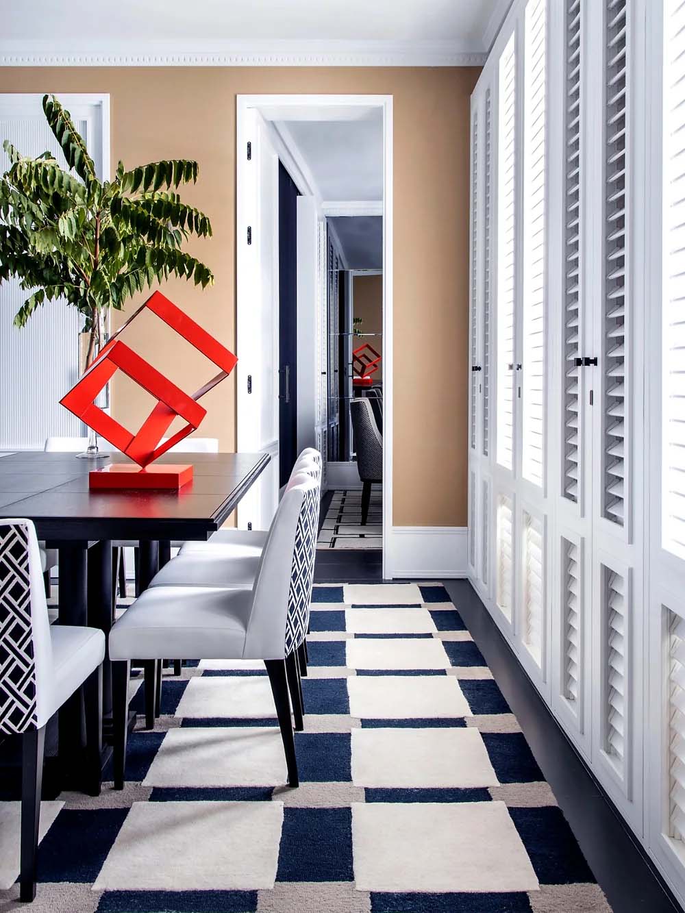 Vista pasillo. Decoración en tonos grises azulados con llamativos elementos rojos.