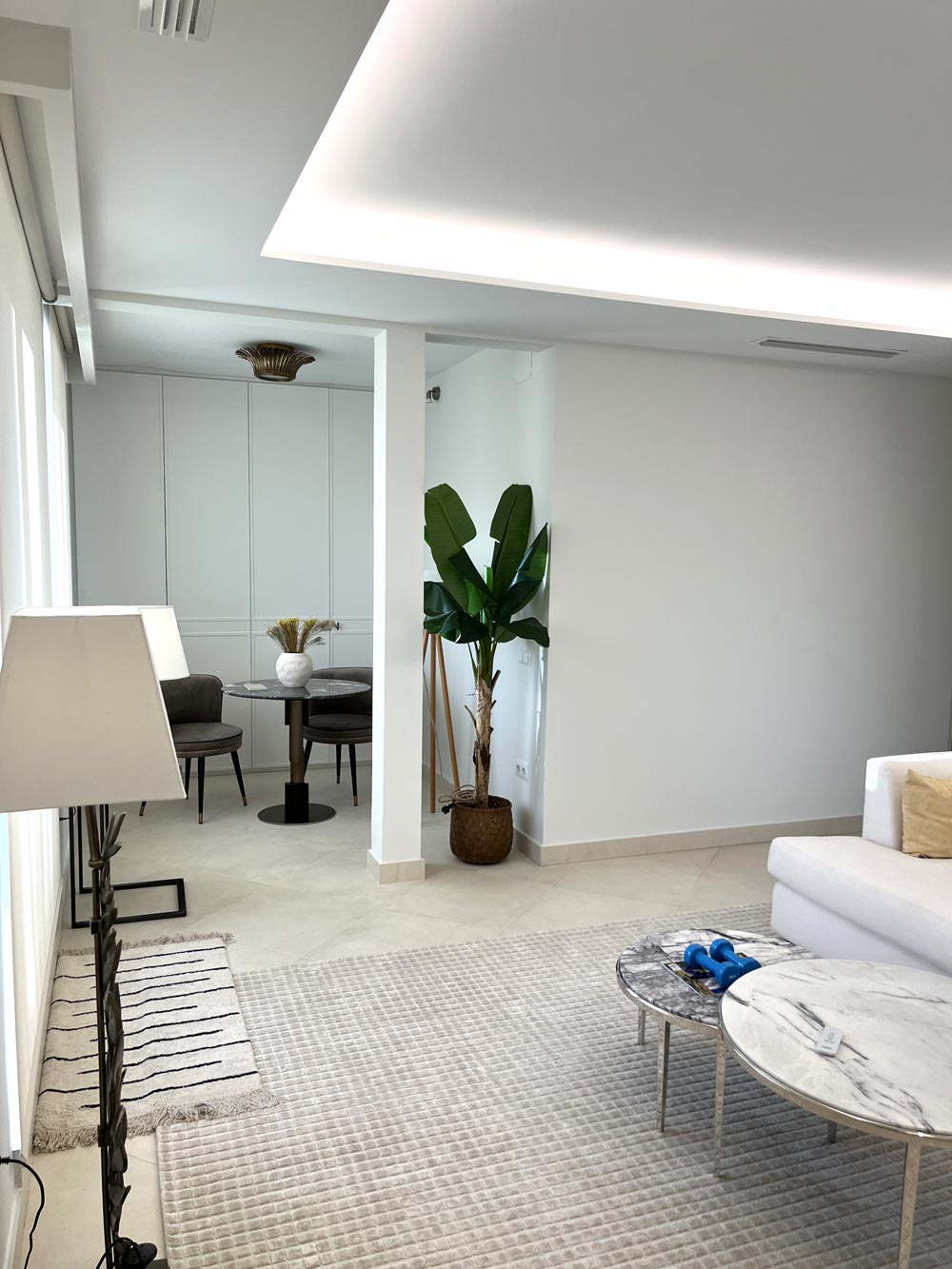 Interior salón blanco con iluminación superior.