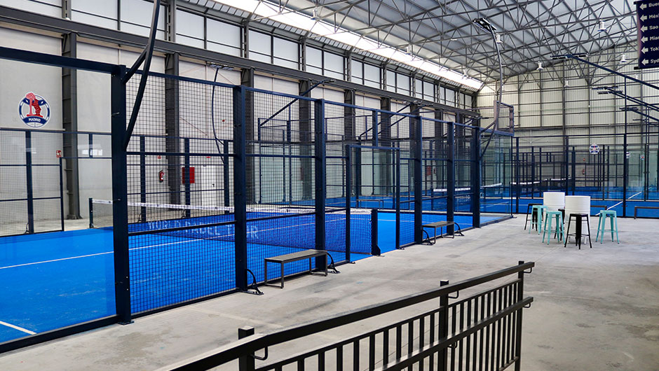 Vista interior de pistas de padel construidas en una antigua nave industrial